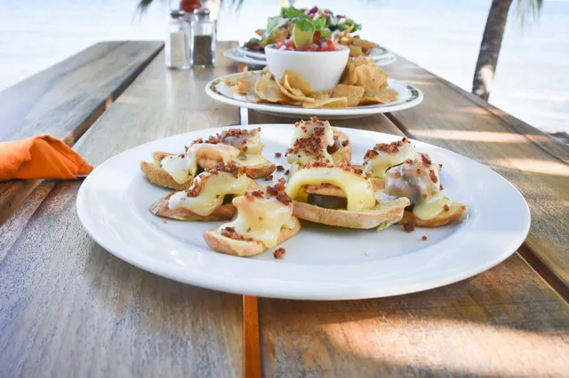 Shared appetizers on an oceanfront table