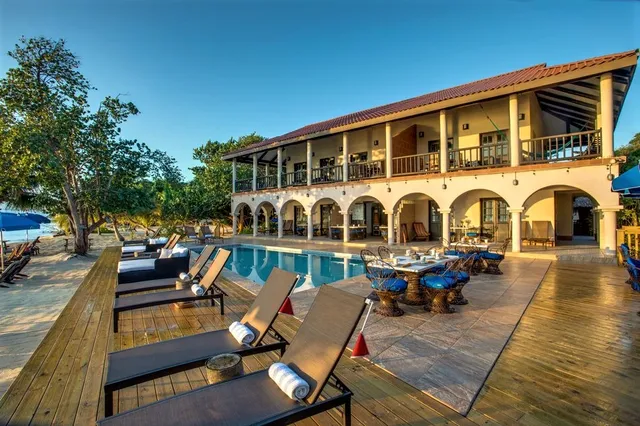 The pool and resort facade with loungers