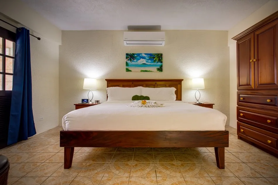 A suite bedroom with warm wood furnishings