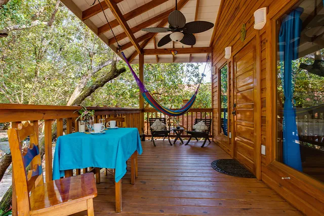 A garden treehouse porch with hammock